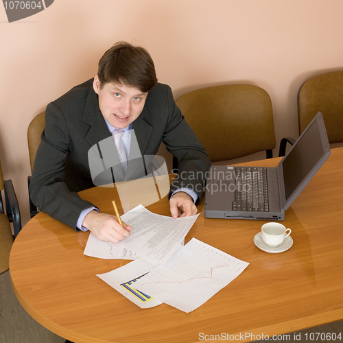 Image of Businessman on a workplace with the laptop