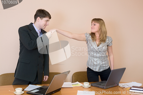 Image of Young businessmen welcome each other
