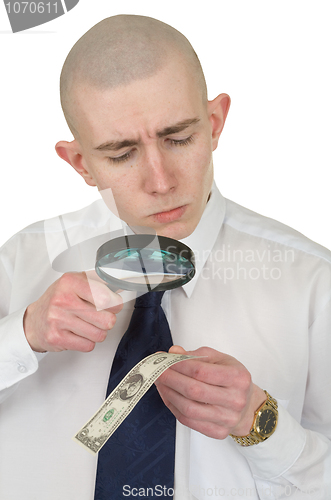 Image of Man studying a counterfeit money