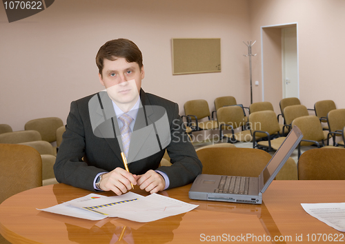 Image of Businessman at a table with laptop