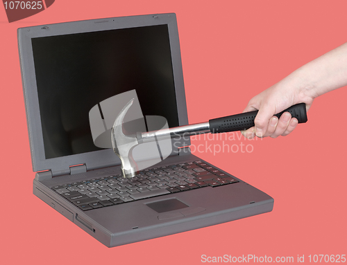 Image of Laptop and hand with hammer