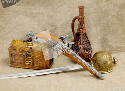 Image of Bottle, rapier, sword, pistol and chest