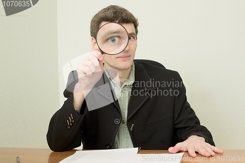 Image of Clerk at office with magnifier