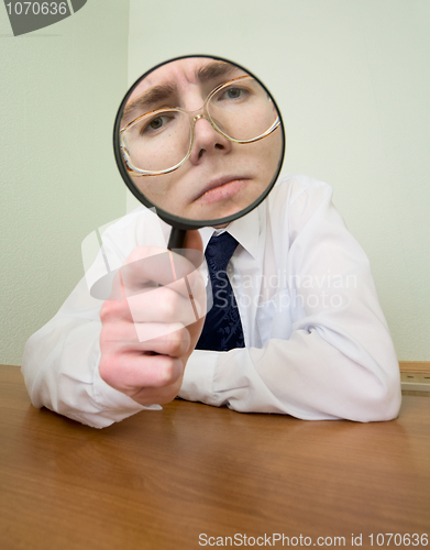 Image of Man with a magnifier in a hand