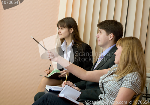 Image of Group of businessmen sitting on armchairs