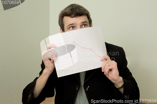Image of Director on a workplace with a graph
