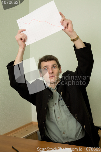 Image of Director on a workplace with a graph