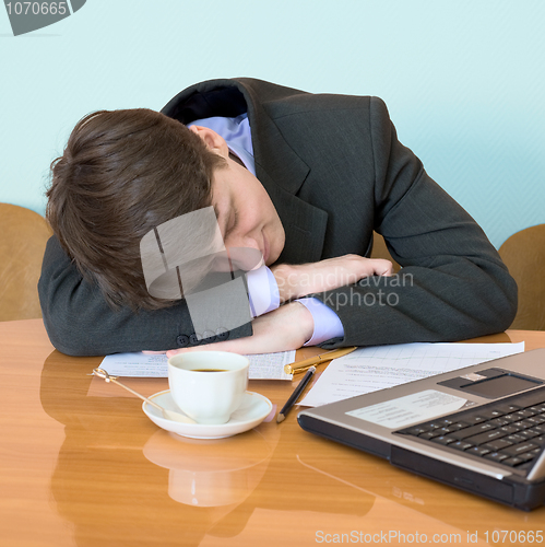 Image of Businessman has fallen asleep sitting at meeting