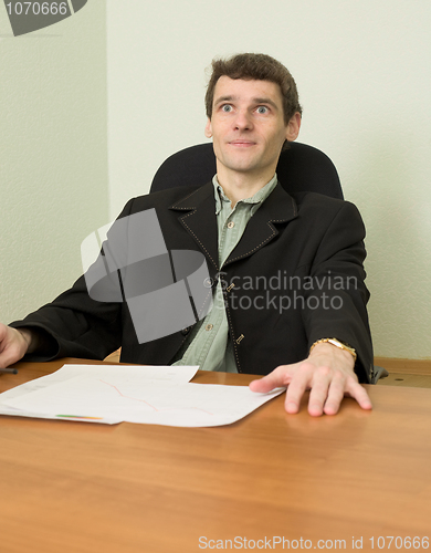 Image of Clerk at office sits at a desktop