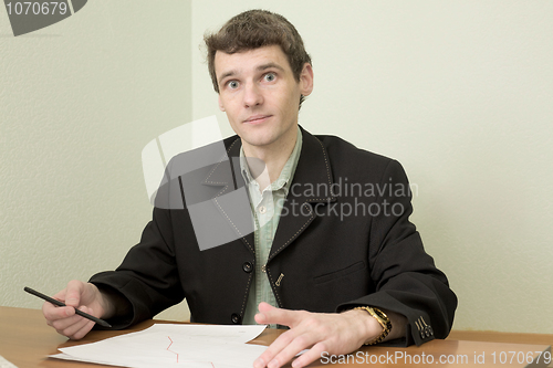 Image of Clerk at office sits at a desktop