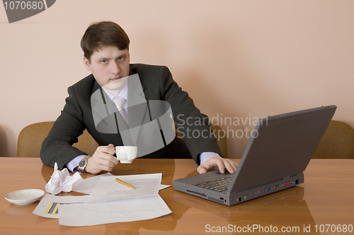 Image of Businessman on a workplace with the laptop