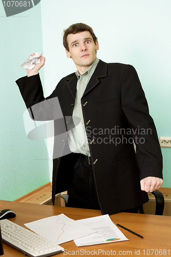 Image of Director on a workplace with a crushed paper