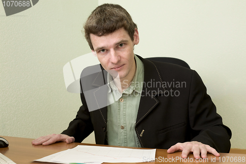 Image of Clerk at office sits at a desktop