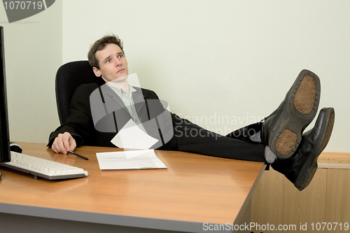 Image of Boss in black suit on a workplace