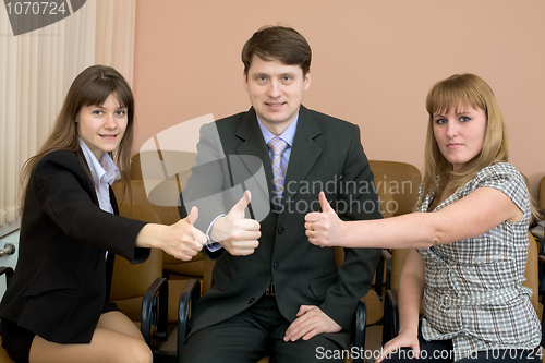 Image of Team of businessmen show thumb up