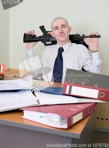 Image of Self-satisfied worker of office armed with a rifle