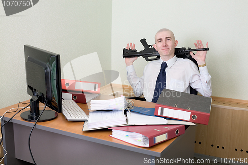 Image of Self-satisfied worker of office armed with a rifle