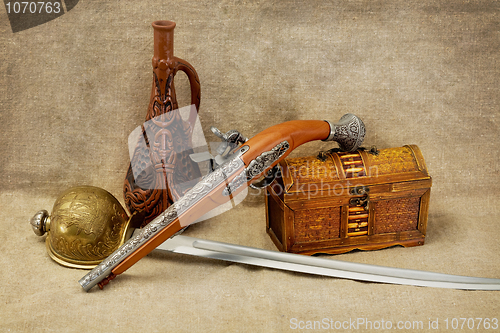Image of Bottle, rapier, sword, pistol and chest