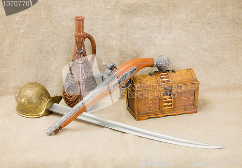 Image of Bottle, rapier, sword, pistol and chest