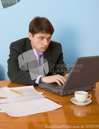 Image of Businessman on a workplace with the laptop