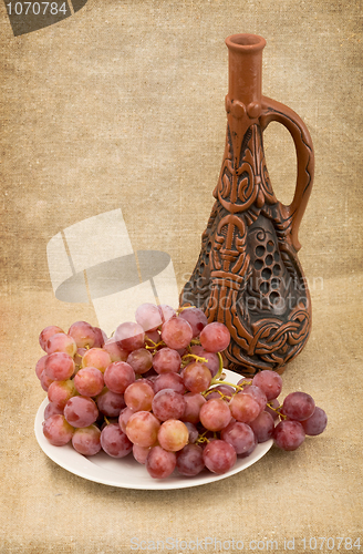 Image of Ceramic brown bottle on canvas background