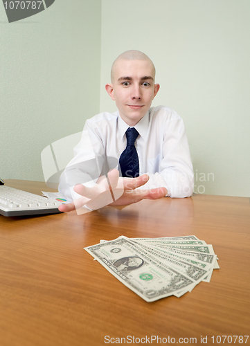 Image of Man reaches for a batch of money