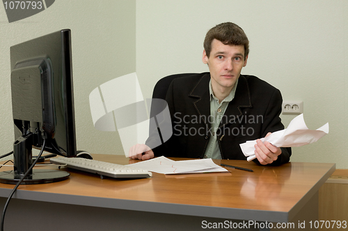 Image of Director on a workplace with a crushed paper