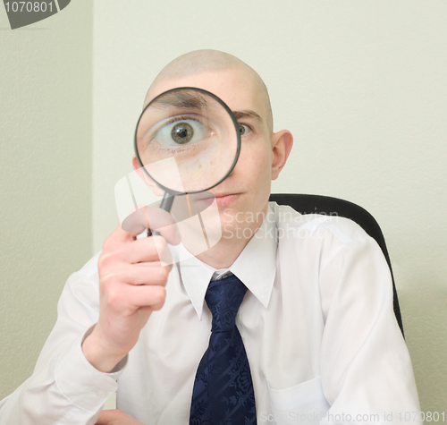 Image of Guy looks through the big magnifier