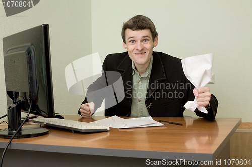 Image of Director on a workplace with a crushed paper