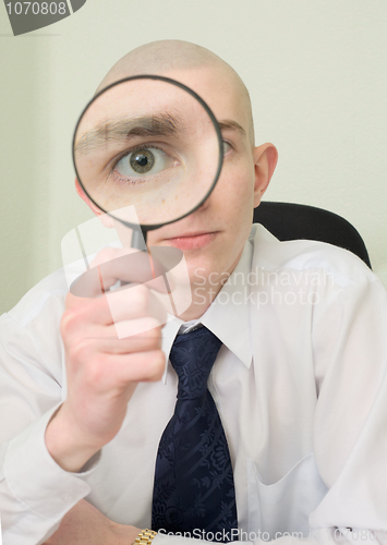 Image of Guy looks through the big magnifier