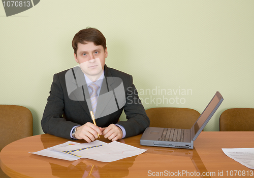 Image of Businessman at a table with laptop