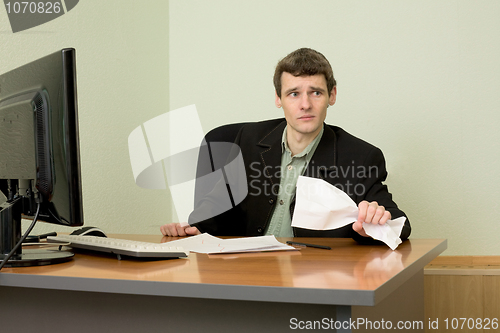 Image of Director on a workplace with a crushed paper