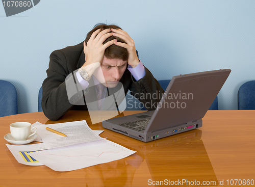 Image of Businessman on a workplace with the laptop