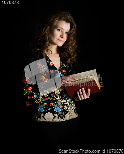 Image of Girl with book on black background