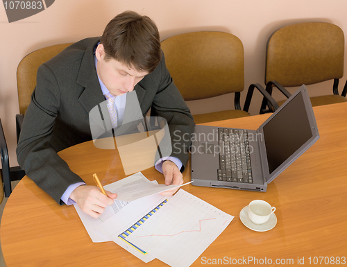 Image of Businessman on a workplace with the laptop
