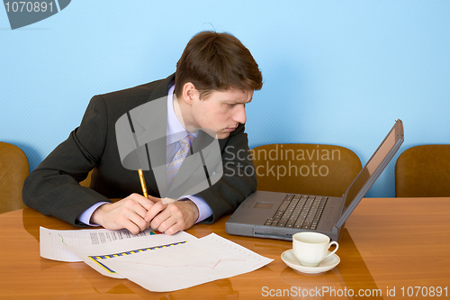 Image of Businessman on a workplace with the laptop