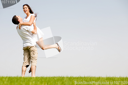 Image of young Couple Fooling Around On The park