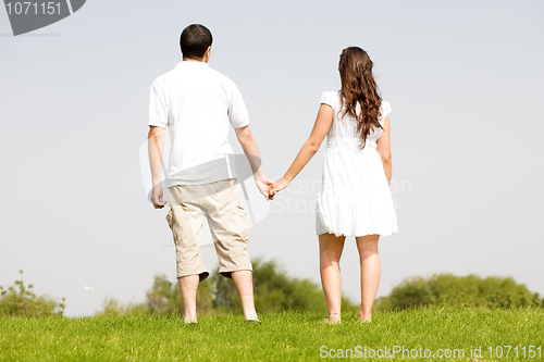 Image of young couple holding hands