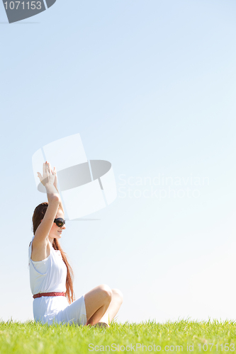 Image of young women sitting and doing meditating