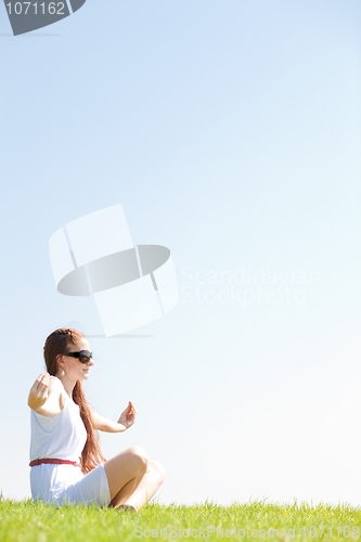 Image of young women sitting and doing meditating