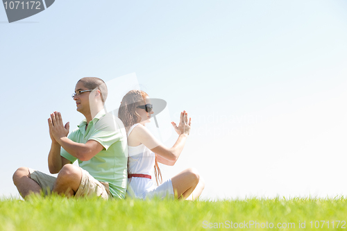 Image of young couple doing meditating