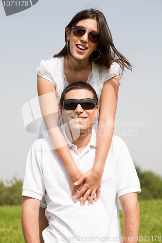 Image of young Couple Sitting Together Outside