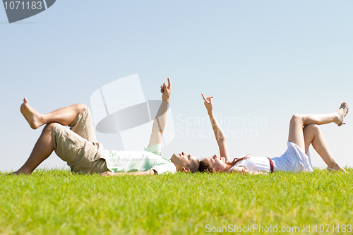 Image of couple lie down on grass