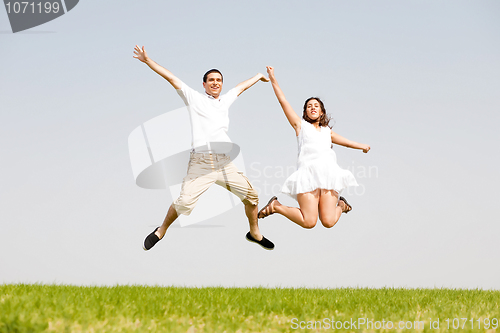 Image of Young Couple Jumping