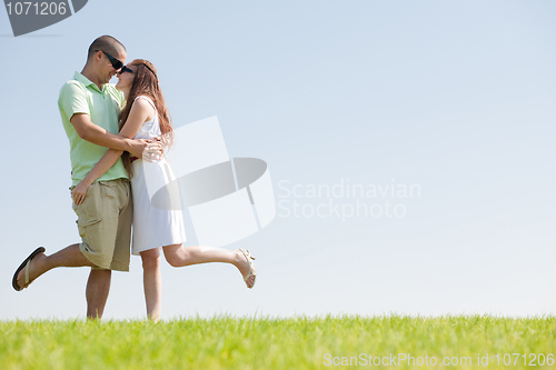Image of young Couple Fooling Around On The park
