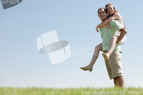 Image of Young Man Piggybacking His Girlfriend