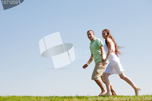 Image of young Couples Running At Park