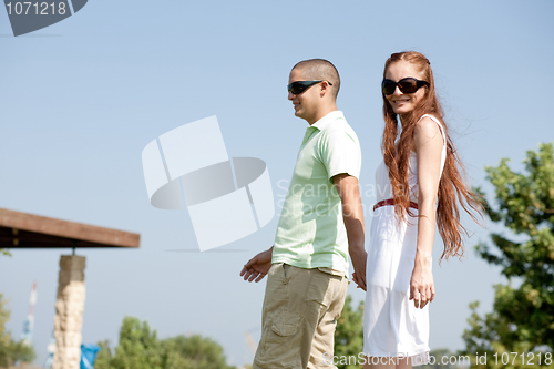 Image of young couple walk on the park