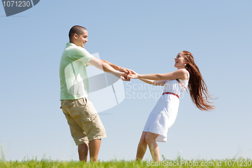 Image of young couple play at park