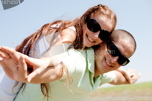 Image of Young Couple Piggybacking